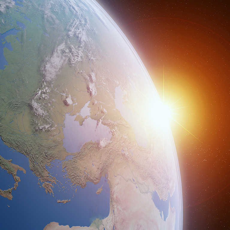 Sun rising over view of blue planet focussing on Europe in space with atmosphere, elements of this image furnished by NASA